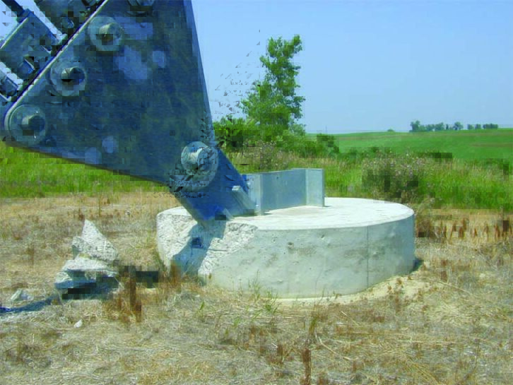 Fig. 1: Lightning from a strike to a guy wire resulted in severe damage to a guy footing.