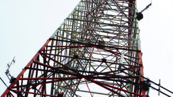 Shot looking up at tall telecommunication tower.