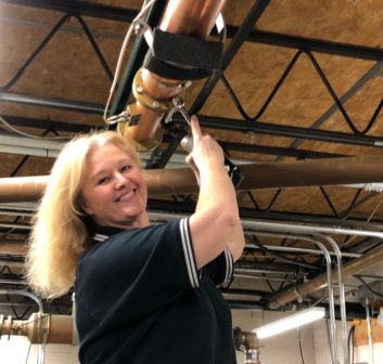 Photo of Sherri Powers working on part of the transmission system for Beasley Detroit