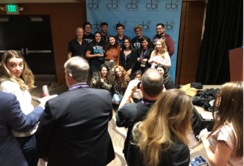 Attendees at the National Electronic College Media Convention in 2018 celebrate an award for KTSW(FM) in Texas in an image from the CBI Twitter feed.