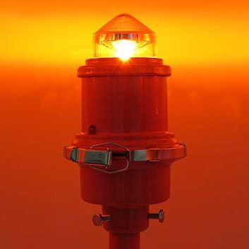 An L-810 LED red obstruction light from Flight Light Inc. is compatible with night vision equipment.