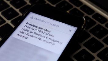 A phone displays a presidential emergency alert test message in 2018 in New York City. (Photo Illustration by Theo Wargo/Getty Images)