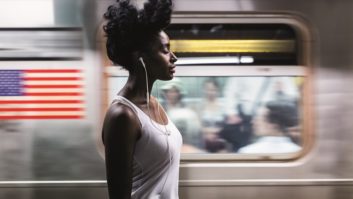 Woman listens to audio while commuting in Manhattan, NYC