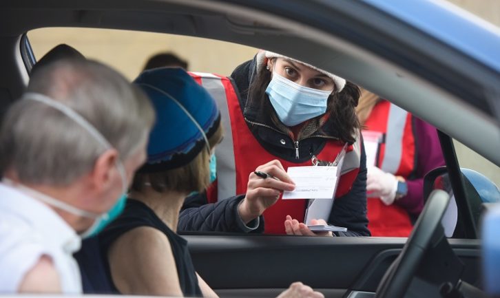 A team member talks to patients about their vaccinations. Photo by Cyrus McCrimmon for UChealth