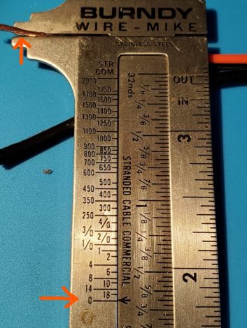 Marc Mann's wire gauge shows that his 18-gauge wire actually measured 20-gauge; note the red arrow.