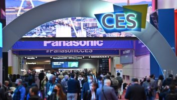 2022 CES Show attendees walking in a hallway with show signage