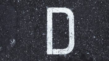 A photo of the letter D on pavement