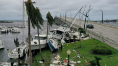 Boats are pushed up on a causeway after Hurricane Ian passed through in Fort Myers, Fla.