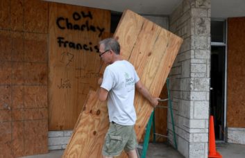 Jim Shipley boards up his Beach Hardware store as he prepares for the possible arrival of Hurricane Ian on Tuesday in St Petersburg Beach, Fla.