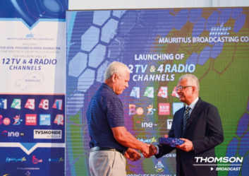 Two officials shake hands at a ceremony marking the installation of new radio and TV transmitters for Mauritius Broadcasting