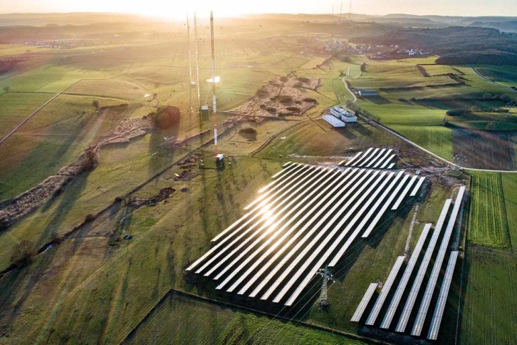Radio antennas behind solar panels at the Beidweiler, Luxembourg, transmission site. After RTL ends its longwave service at year-end 2022, the towers will be removed and replaced with more solar panels.