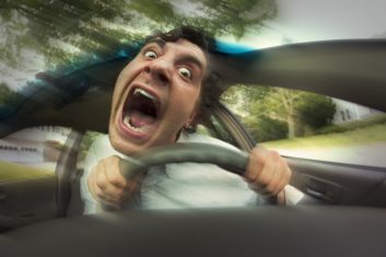 A stylized photo of an upset male car driver with eyes bugged out and mouth open in a scream