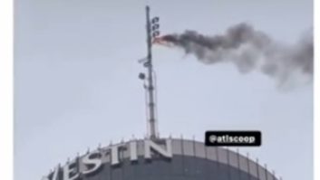 Screen image of a Facebook video showing smoke coming from the FM broadcast antenna atop the Westin in Atlanta