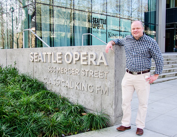 Erik Utter stands in front of the Seattle Opera building, which includes studios of KING-FM