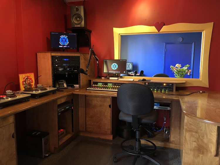 WXOX’s Studio A,painted in red, looks into a performance area through a custom window. 