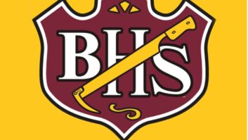Logo of Brush High School, a red badge on a golden background, with the letters BHS and a beet-digging tool