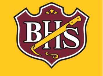 Logo of Brush High School, a red badge on a golden background, with the letters BHS and a beet-digging tool