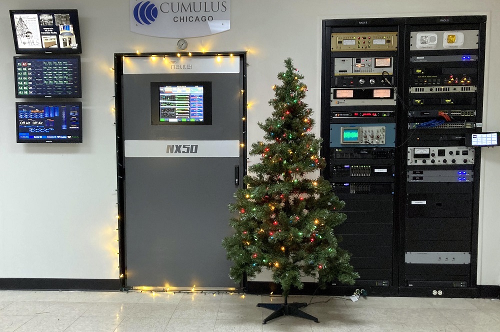 The transmitter room of WLS(AM) radio station in Chicabo with a Christmas tree in front of the Nautel transmitter
