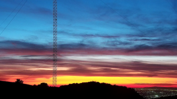 Sunset view of the KBRT Oak Flat transmitter site in the Santa Ana Mountains, looking down on a populous part of eastern Orange County, Calif. Part of a radio tower is at left, near the viewer.