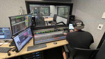 A man sits at a Wheatstone console inside a radio studio at SENZ