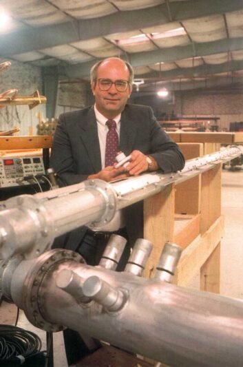 Edward Edmiston stands with part of an antenna at the SWR factory