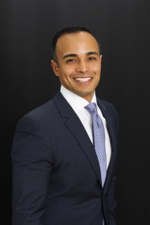 headshot of Chad Lopez, a man in a business suit