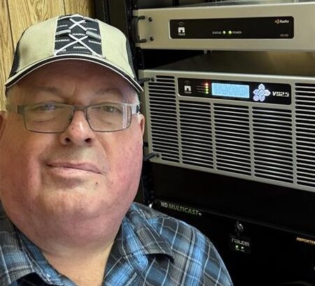 Family Radio Regional Engineer Tommy Jenkins with 93.7 WFRW(FM)'s transmitter rack.