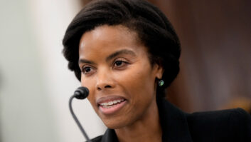 A woman sits before a microphone in a U.S. Senate committee room.