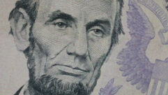 A closeup of the image of Abraham Lincoln from the five-dollar bill