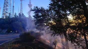 Firefighters mop up hot spots near the towers on Mount Wilson as the Eaton Fire continued to burn on Jan. 9 near Altadena, Calif. Credit: David McNew/Getty Images