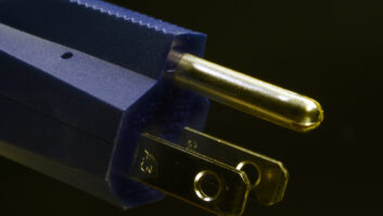 Close-up of a type B electrical plug. The type B plug (USA) has two flat parallel pins and one round ground pin.