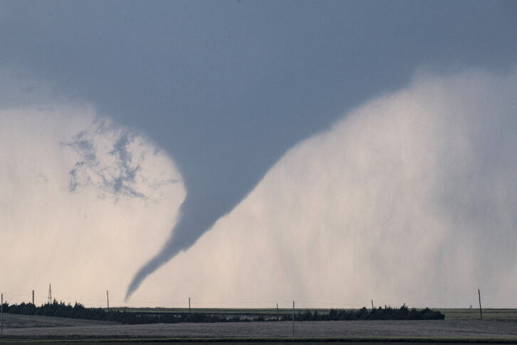 DODGE CITY, KS - MAY 24: A tornado is seen south of Dodge City, Kansas moving north on May 24, 2016 in Dodge City, Kansas. About 30 tornadoes were reported on Tuesday in five different states from Michigan to Texas. Damage to homes and property was also reported in Ford County, Kansas.