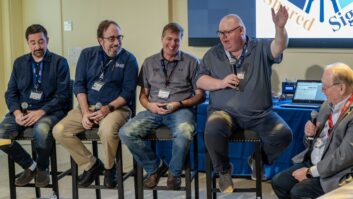 Several men sit on stools for a roundtable discussion