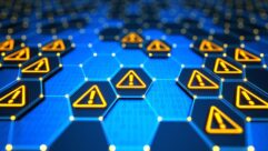 An abstract image suggesting warning or alerting, consisting of a series of blue six-sided shapes, some of which have the symbol for "alert" in yellow
