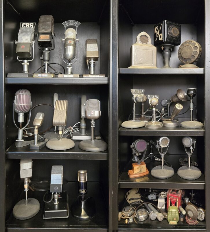 Shelves with dozens of old-style broadcast microphones