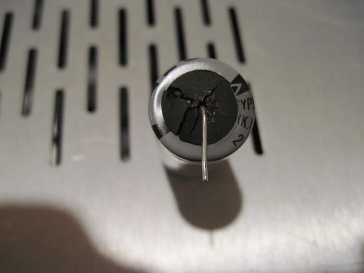 Fig. 1: A blown seal on an electrolytic capacitor points to the need for wholesale replacement of all electrolytics.
