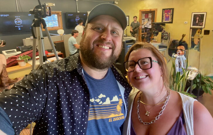 Andy and Katie Gladding at the studios of 98.1 WKZE(FM) as the band The Low Darts prepares for a live broadcast. The couple purchased the station in March.