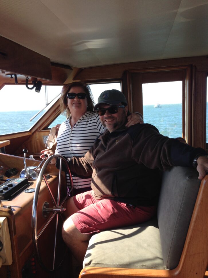 Bullett and his wife Lisa aboard the “Chartmaker,” their 58-foot Hatteras Motor Yacht, on San Francisco Bay. He describes the boat as their happy place.
