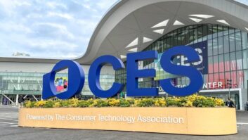 Large blue letters spell out CES in a freestanding sign in front of the Las Vegas Convention Center