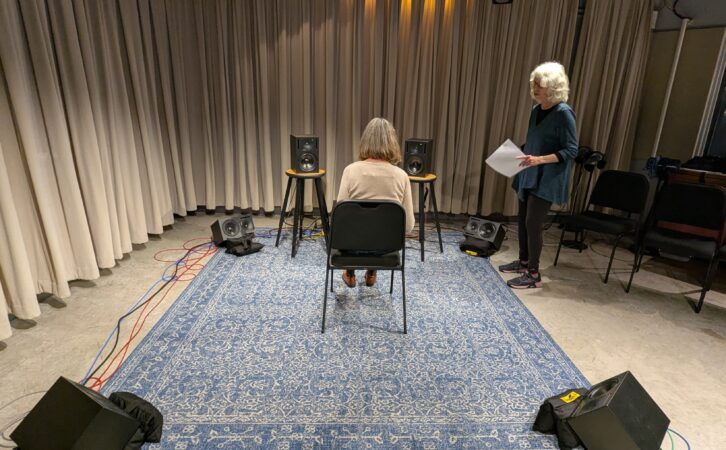 Listening test setup at New York Public Radio in November. Dr. Ellyn Sheffield talks with a participant.