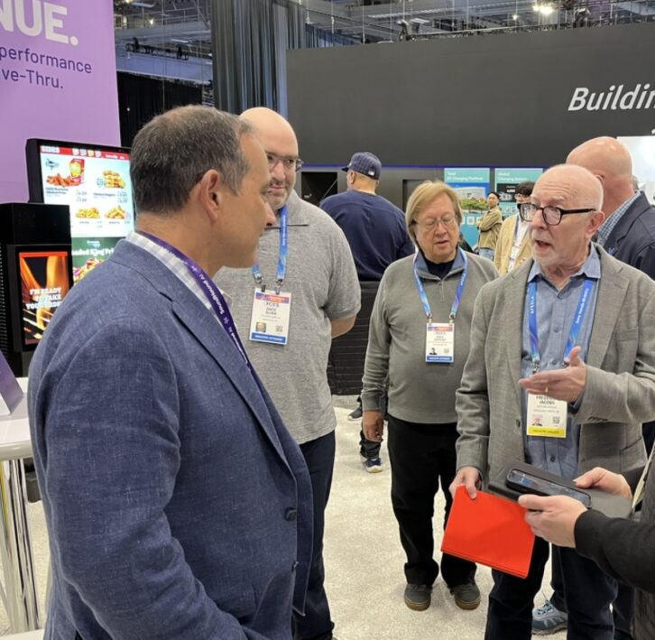 Fred Jacobs visits the SoundHound booth. The exhibitor highlighted its agentic AI offerings.
