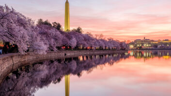 Pink skies over the Tidal Basin and Washington Monument in Washington, D.C., while the yoshino cherry trees are in full bloom. Credit: John Baggaley/Getty Images