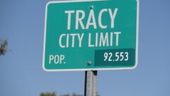 A road sign that states "Tracy City Limit, Pop 92,553"