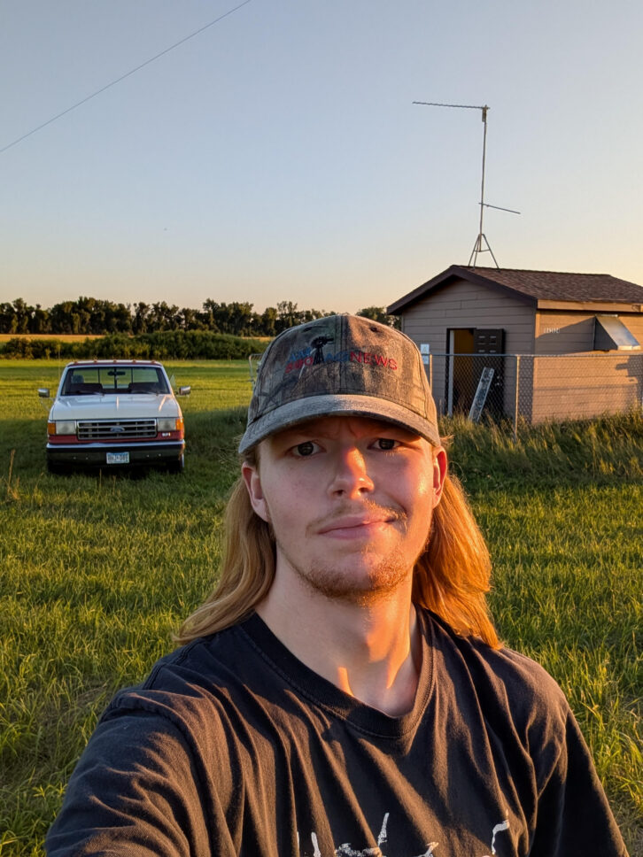 Roman Porterfield in front of KQLX(AM) in summer 2025.