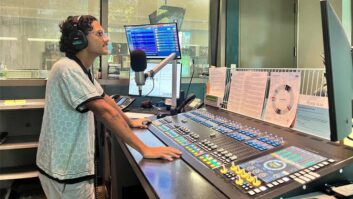 Host Juan Garcia operates the Quasar mixing console in the KUT Live studio.