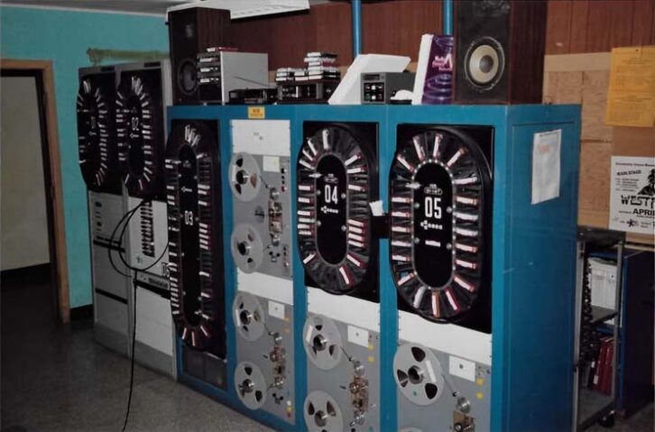 This photo shows equipment at WKAI(FM) in Macomb, Ill., in the early 1990s. There are four 42-tray IGM Go-Carts, one 78-tray Go-Cart and one 12-tray Instacart, numbered 01 through 06, along with other audio sources.