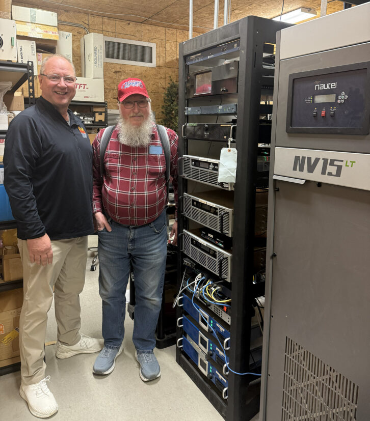 Brian Lundquist, left, and Chief Engineer Don Brintnall in a room loaded with Nautel transmitters.