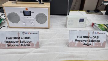 Dual DRM and DAB+ digital radio receiver solutions, developed by RF2DIGITAL Inc., on display at the DRM General Assembly in Jakarta, Indonesia. Featured are the "Wooden Radio" tabletop model (left) and the compact "Jogja" portable receiver (right).