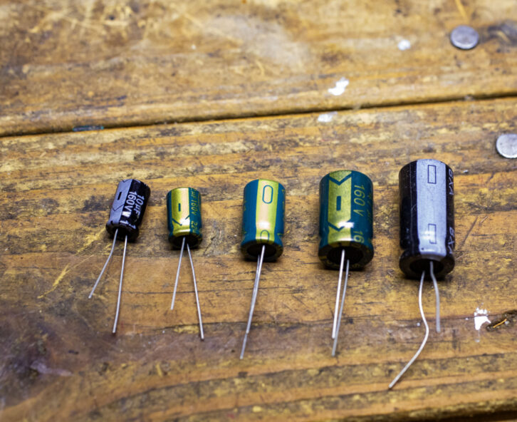 Examples of radial electrolytic capacitors. From left to right: 10, 22, 33, 47 and 100mf.
