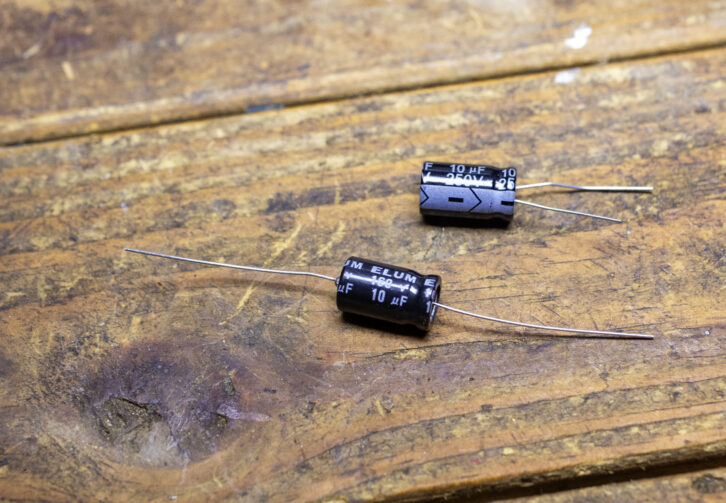 Two examples of a 10 mf capacitor. The one on the bottom is an axial and 160 volts. Above is the 250 volt radial. Note that the negative lead is shorter on the radial.